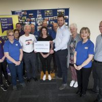 FDST CHEQUE HANDOVER. . . .Mr. John Clarke pictured handing over a cheque for £500 to Christopher Cooper, manager, Foyle Down Syndrome Trust, proceeds of sponsored walks by the REAL CLUB Walking Group (made up of retired Du Pont employees, who meet up weekly for walking ventures throughout the north-west). In centre is Sinead Lynch, mother of the late Ruby, a child who attended FDST and who passed away last year. John is also Ruby’s grandfather.