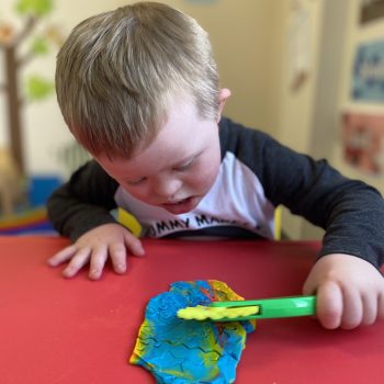 Tiernan cutting playdough 1